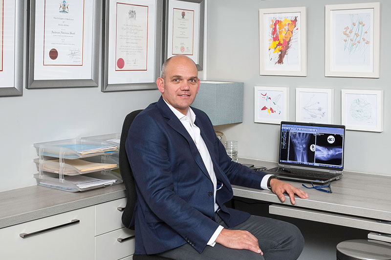 Dr Adriaan Smit seated in his consulting room